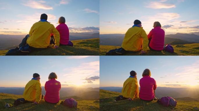 日落时分，SLO MO CS高级夫妇坐在山顶上欣赏美景