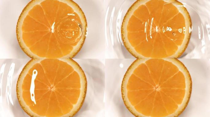 橙色切片上落水的超慢动作。在高速电影摄影机上拍摄