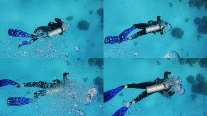 探索红海的潜水点。潜水员向海底下降，气泡接触相机镜头