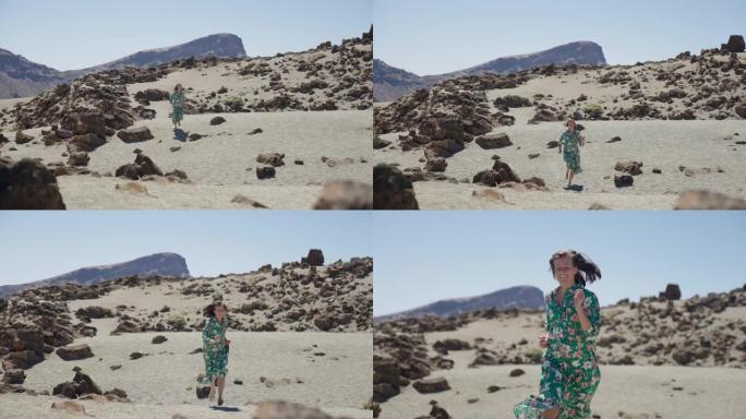 幸福和自由。女人在岩石干燥的风景中奔跑和微笑。享受山脉
