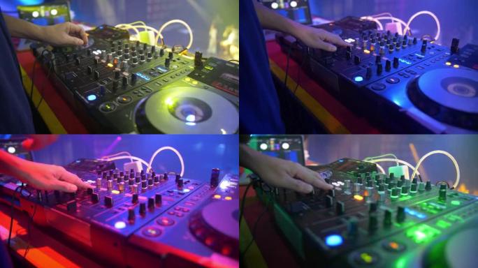 DJ在夜总会使用混音控制台