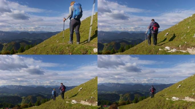 一个高级男人和一个女人在阳光下的风景优美的小径上下山