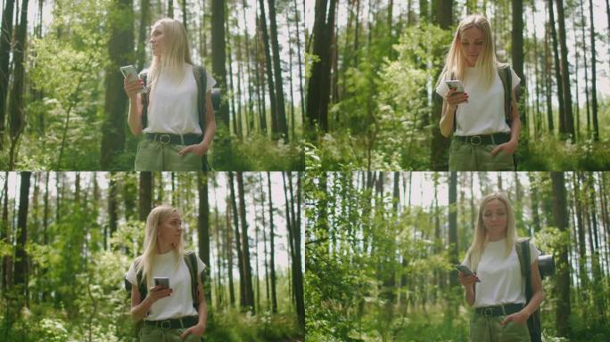 迷人的女人在森林里放松，在户外使用智能手机。女人在森林里徒步旅行，在智能手机上输入信息。使用智能手机