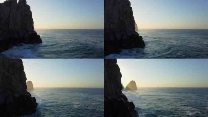 空中无人机在日出时拍摄了岩石悬崖一侧
