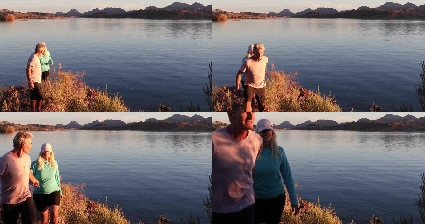夫妇在日出时从湖岸线上欣赏风景