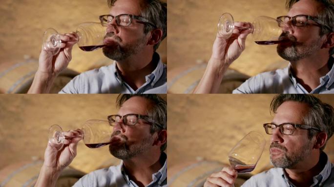 一个男人品尝红酒的细节照片