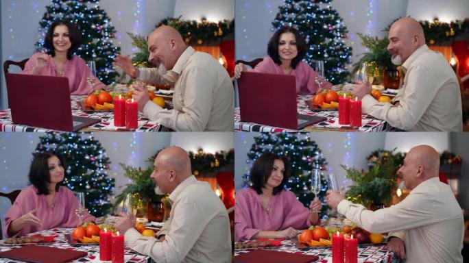 微笑的男人在笔记本电脑上挥手告别视频聊天，与模糊的女人碰碰香槟杯。快乐积极的高加索夫妇在网上在家庆祝