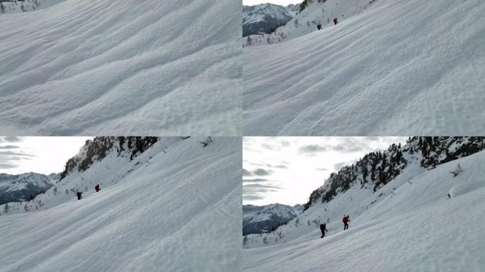 两名滑雪者在雪山山谷中冒险的空中无人机拍摄