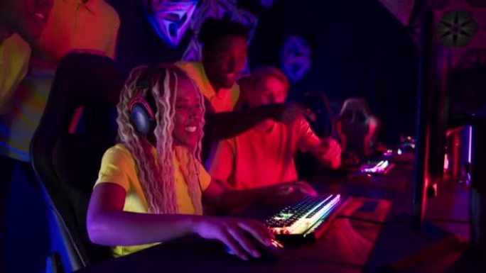 多样化的黄色职业玩家团队与非洲族裔玩家一起参加视频游戏eSport冠军赛。为决赛选手加油打气