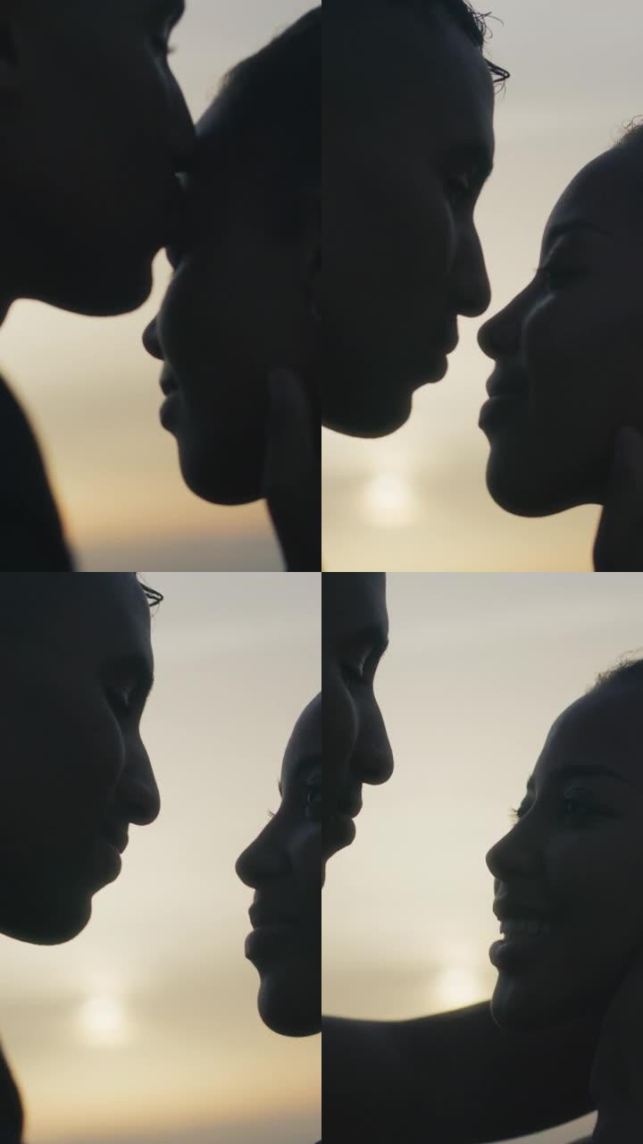 日落浪漫约会的特写非洲族裔夫妇。爱拥抱垂直视频