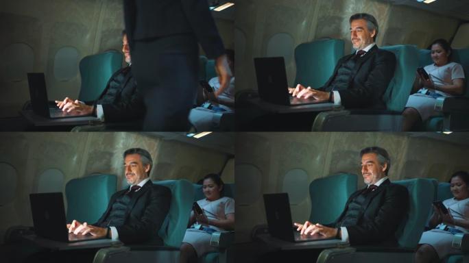 商人在飞机上使用笔记本电脑