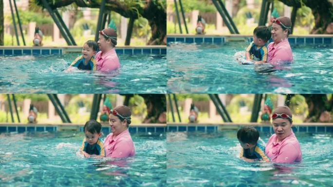 小男孩喜欢和私人老师一起上游泳课。