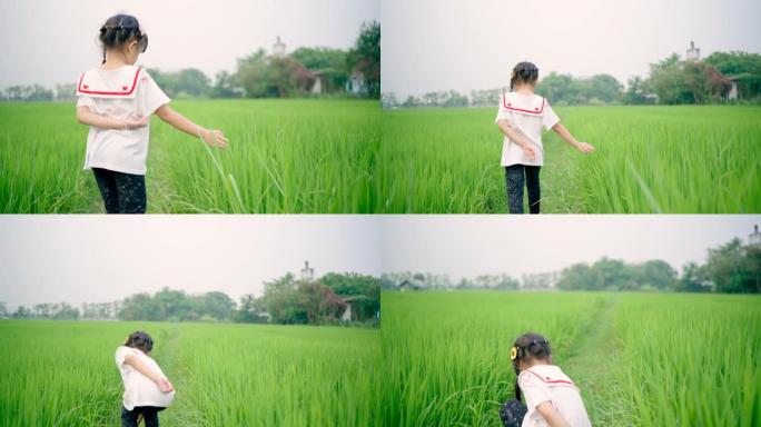 亚洲女孩快乐快乐地走在绿色的田野里。