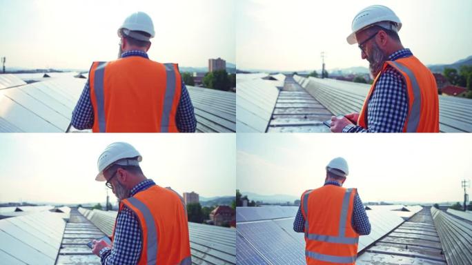 TS男工程师在太阳能发电厂屋顶的一排排光伏电池板之间行走