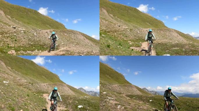 女子山地自行车沿高山路径的第一人称视角