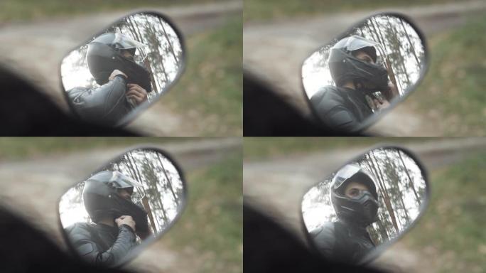 自信的年轻人紧固摩托车头盔的侧镜反射。自信的中东男赛车手准备乘车。赛车和肾上腺素概念。