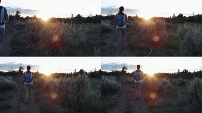 日落时在锡安国家公园徒步旅行的女人