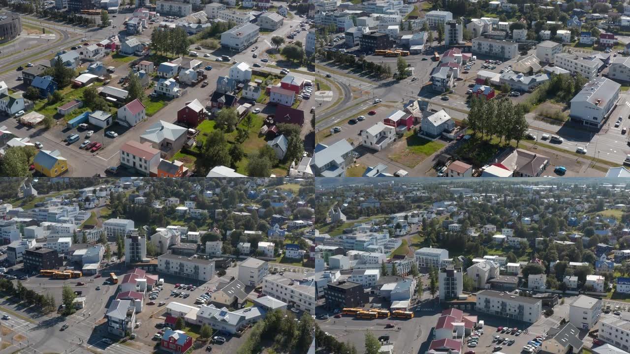 城市小区住宅的高角度视图。向前飞过镇上的家庭住宅和街道。向上倾斜的山脉
