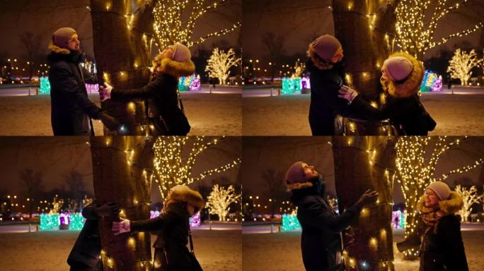 在一个下雪的夜晚，一对夫妇在慢动作中拥抱圣诞树。玩捉迷藏
