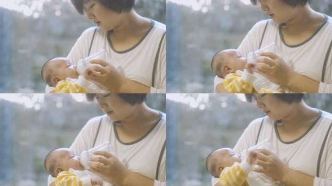 母亲用奶瓶喂养婴儿