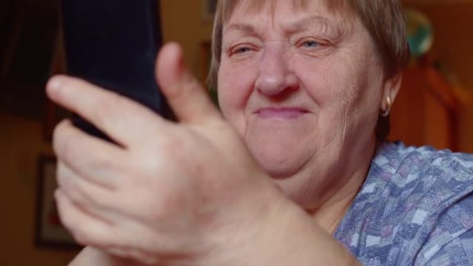 Senior woman watch funny video on smartphone