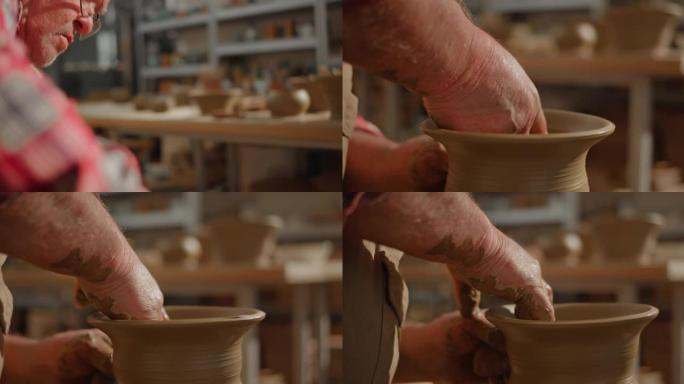 高级男陶工在陶工的轮子上制作花瓶