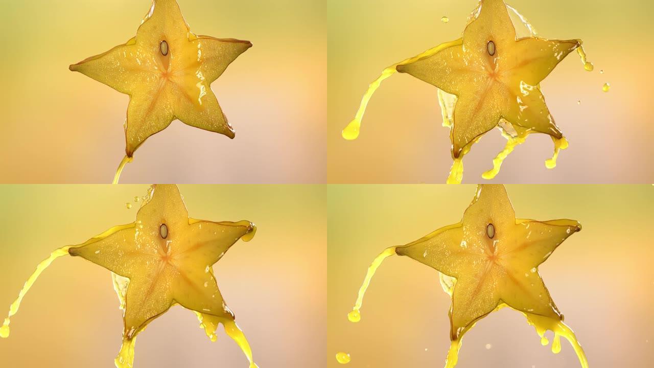 从切成两半的杨桃明星果实中流动的杨桃汁的慢动作宏观拍摄