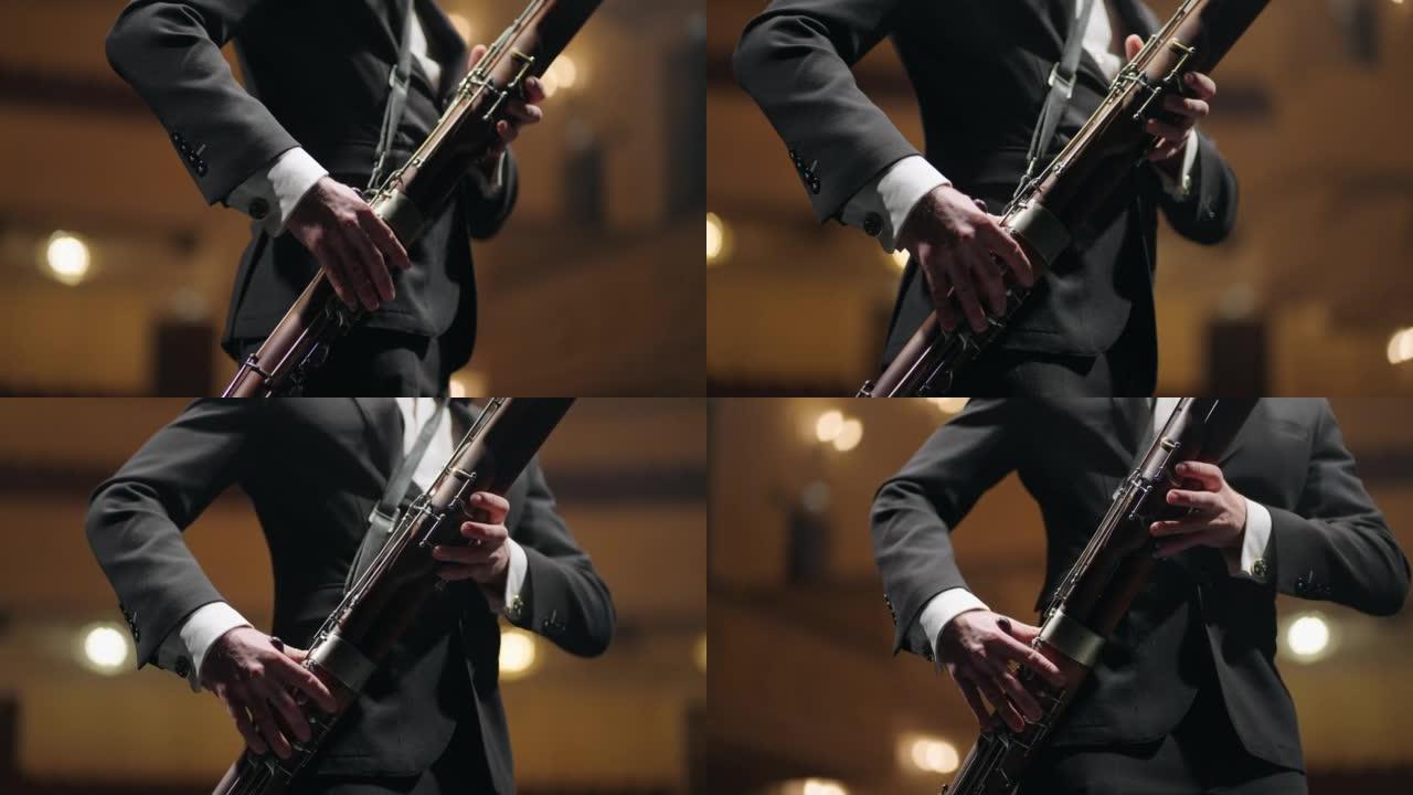 才华横溢的bassoonist在歌剧院的音乐会上演奏音乐，现场有bassoon的音乐家