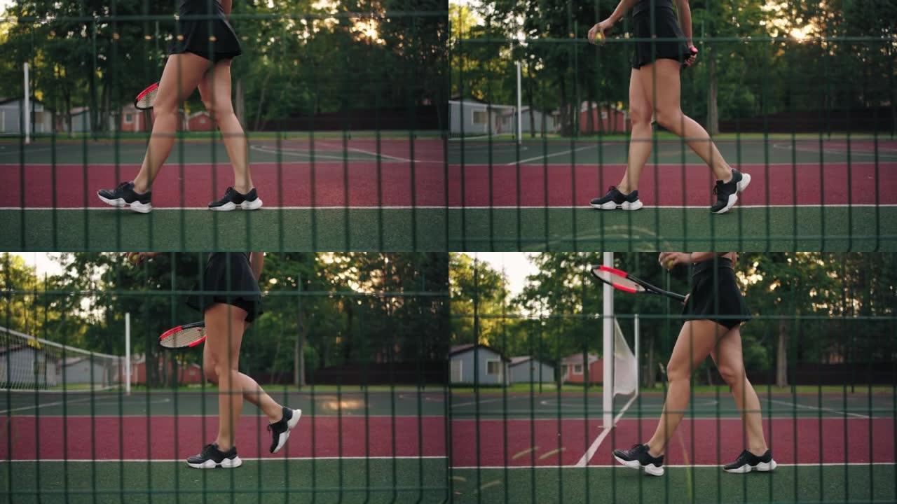 年轻性感的女士走在网球场上，修长的腿和脚踩运动运动鞋