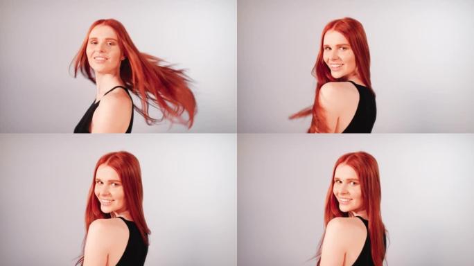 美丽诱人的红发女人扔长发。对着镜头微笑