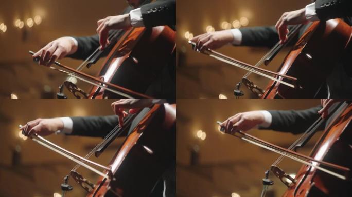 才华横溢的人在老歌剧院的现场演奏大提琴，大提琴手的特写镜头