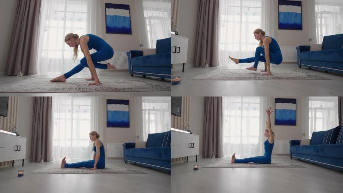在家的女人足不出户就做瑜伽练习。家庭培训。一个女人穿着蓝色西装在地毯上训练