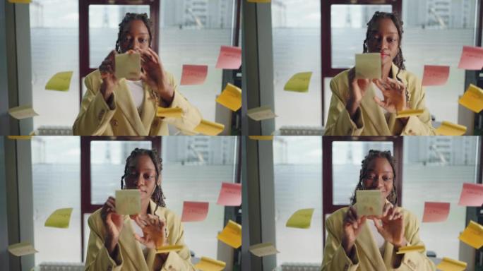 African american business woman using sticky notes