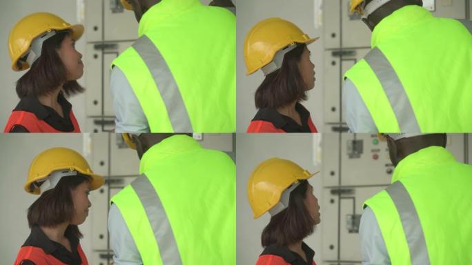 仓库工人在工厂看控制面板