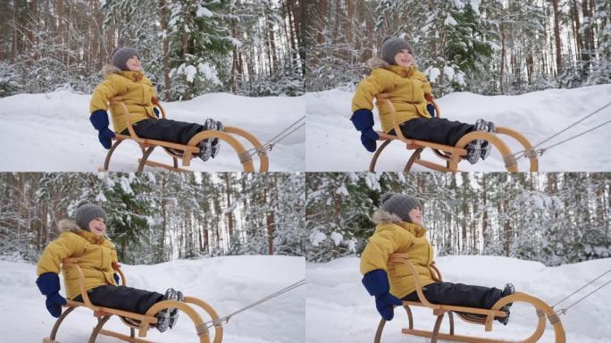 可爱的蹒跚学步的孩子在冬季森林里骑着雪橇，在大自然中的家庭散步中享受快乐和快乐