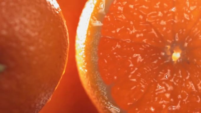 滚动一半的新鲜橙子，并以慢动作打开水果的内部。4K