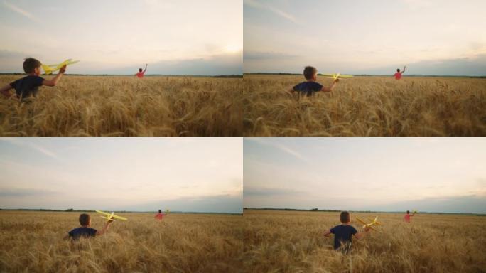 乡村快乐的童年，小男孩在金色的田野里奔跑，在玩飞机