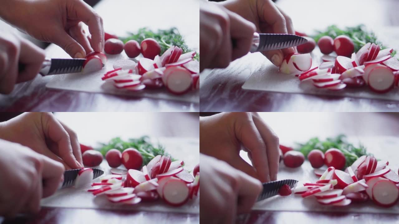 Radishes are cut with a knife on the table. Cuttin