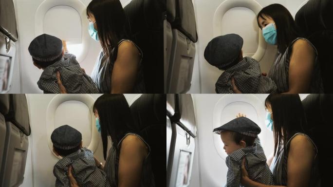 小男孩和他的母亲看着飞机窗外