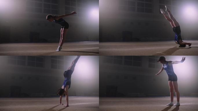 年轻的才华横溢的体育女孩正在体操馆做后空翻，准备参加艺术体操比赛