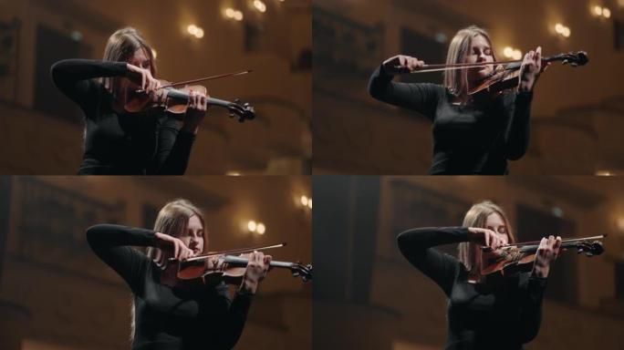 年轻的女小提琴家正在学习在rehersal大厅或歌剧院或音乐厅的现场拉小提琴