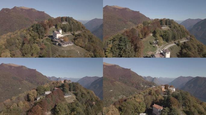 空中无人机拍摄了俯瞰湖泊和山脉的树木繁茂的山顶