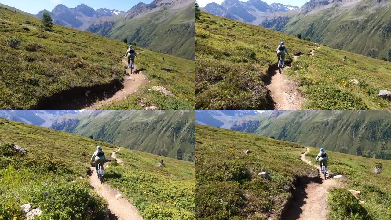 女子山地自行车沿高山路径的第一人称视角