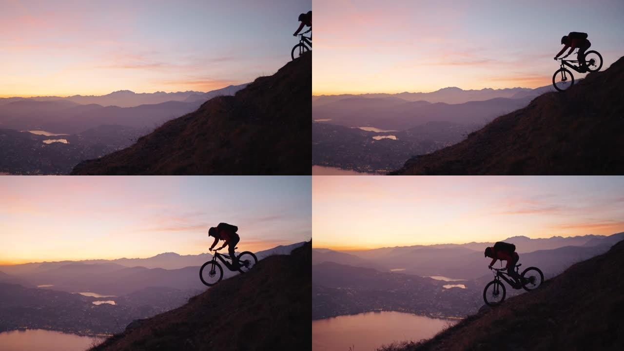 日落之后，在蓝色时刻，山地车手在山顶上骑行