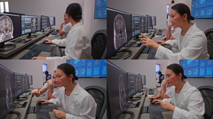 DS女放射科医生在分析头部扫描时向同事寻求建议