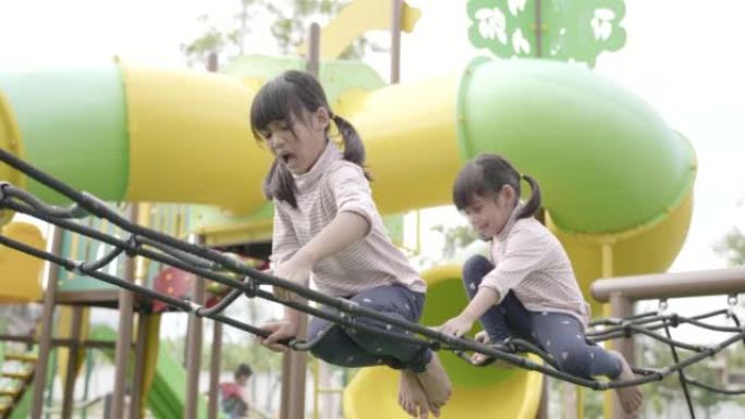 亚洲大姐和小妹在被大流行新型冠状病毒肺炎封锁后在附近家中的操场上玩耍的场景