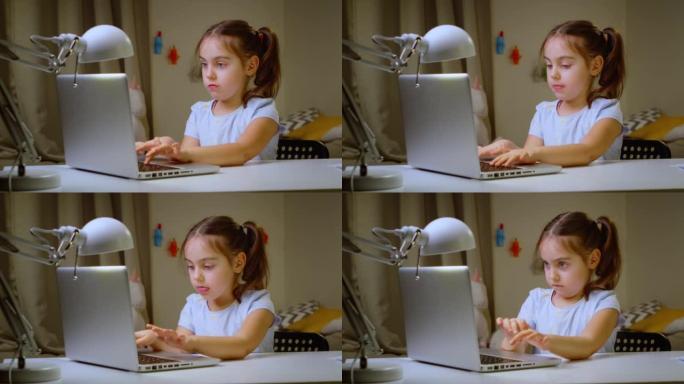 小女孩正在笔记本电脑后面的互联网上与老师在线学习。