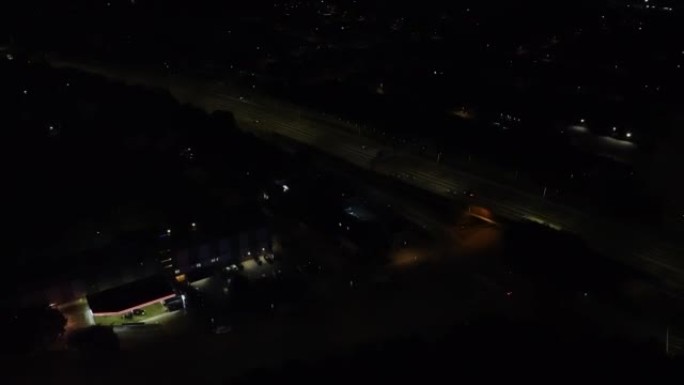在高速公路和英格兰卢顿镇的日出场景之前，空中高角度镜头即将结束。英国的照明城市，高速公路上的交通景观