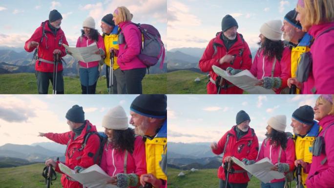 四个徒步旅行者看着地图，在山顶上聊天