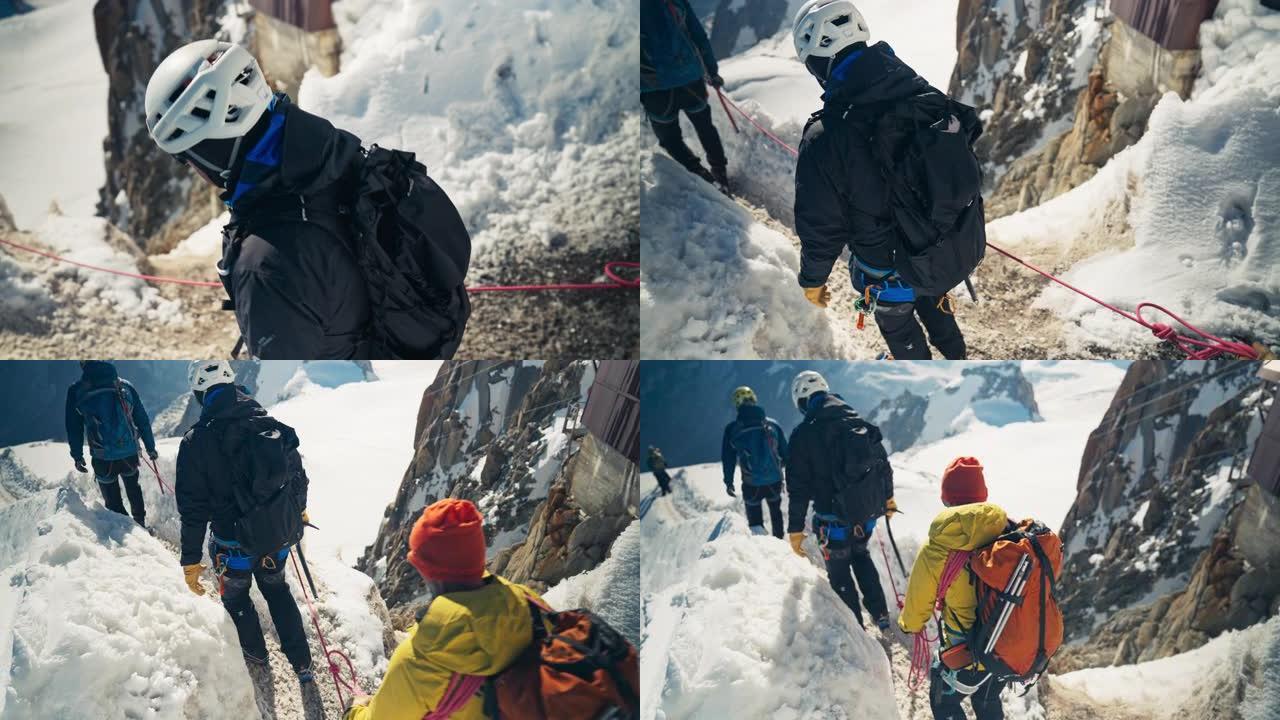 一队登山者连续攀登高峰。冬季冒险。视点